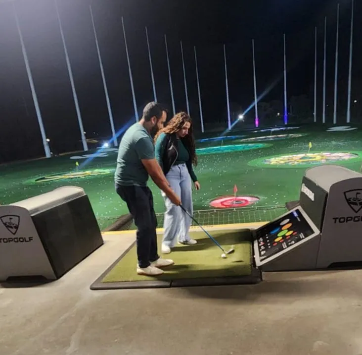 Two residents at Top Golf during a wellness event